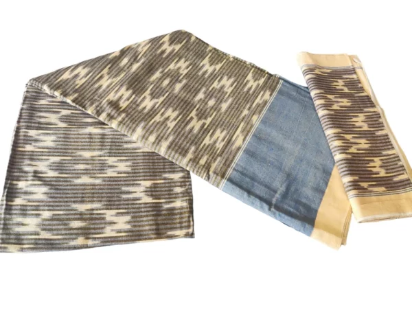 Traditional handloom cotton bedsheet with a vibrant, geometric pattern in shades of orange, brown, and pink, accompanied by a matching pillow cover from PAVANKUMARWEAVES