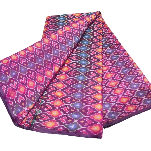 cotton silk fabric with a traditional ikat pattern featuring multicolored diamond motifs arranged in a symmetrical design."