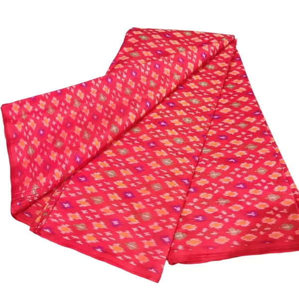 cotton silk fabric with a traditional ikat pattern featuring multicolored diamond motifs arranged in a symmetrical design."