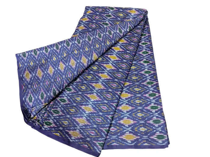 cotton silk fabric with a traditional ikat pattern featuring multicolored diamond motifs arranged in a symmetrical design."