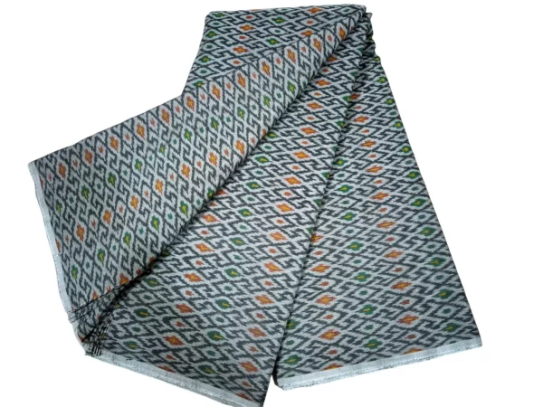 cotton silk fabric with a traditional ikat pattern featuring multicolored diamond motifs arranged in a symmetrical design."