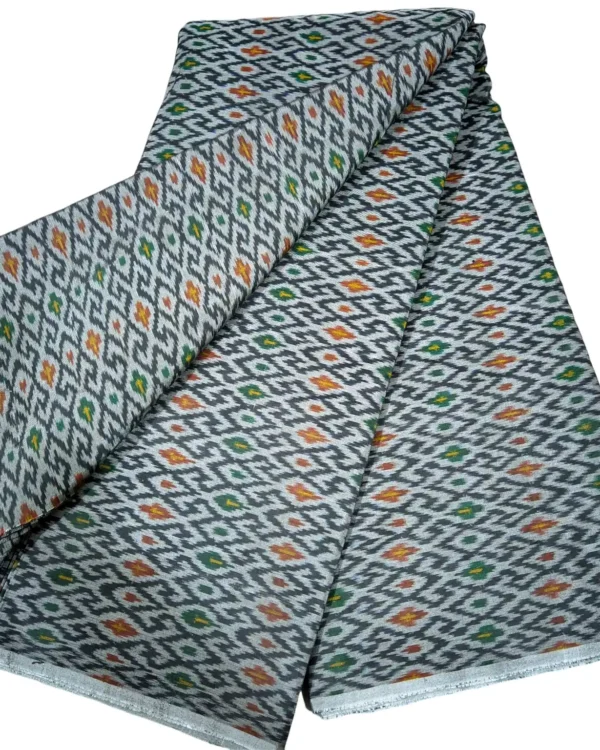 cotton silk fabric with a traditional ikat pattern featuring multicolored diamond motifs arranged in a symmetrical design."