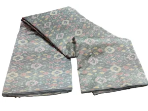 cotton silk fabric with a traditional ikat pattern featuring multicolored diamond motifs arranged in a symmetrical design."