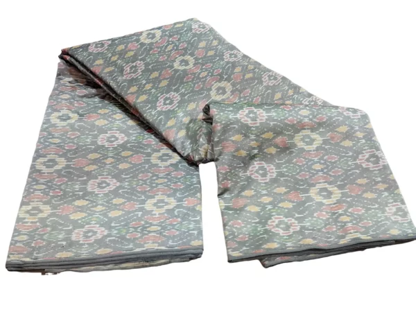 cotton silk fabric with a traditional ikat pattern featuring multicolored diamond motifs arranged in a symmetrical design."
