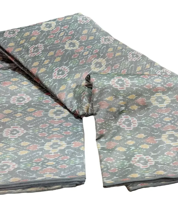 cotton silk fabric with a traditional ikat pattern featuring multicolored diamond motifs arranged in a symmetrical design."
