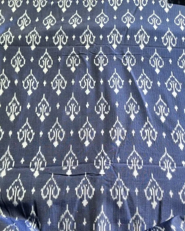 Blue and white ikat fabric featuring intricate diamond motifs, perfect for home decor or apparel
