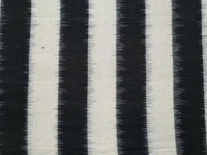 Handwoven double ikat fabric in vibrant tie-and-dye patterns, 45-inch width