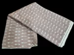 Detailed view of ikat textile with bold zigzag pattern in blue and white