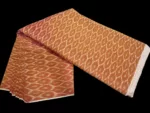 Traditional ikat fabric displayed with vibrant pink and purple tones