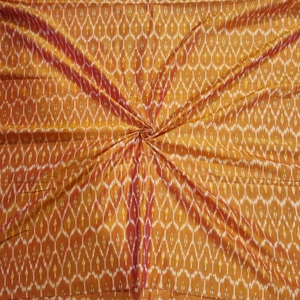 Traditional ikat fabric displayed with vibrant pink and purple tones