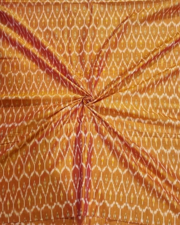 Traditional ikat fabric displayed with vibrant pink and purple tones
