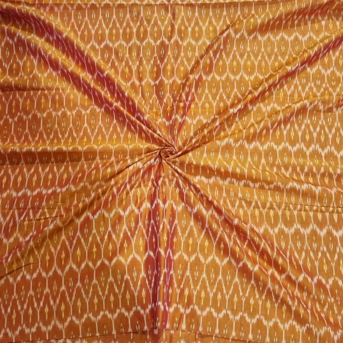 Traditional ikat fabric displayed with vibrant pink and purple tones