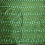 Pure cotton ikat fabric with intricate handwoven design, ideal for dresses and kurtas