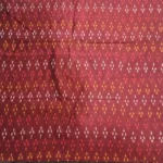 Ethnic ikat fabric draped to highlight its rich texture and colors