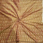 Traditional handwoven ikat fabric featuring colorful diamond motifs