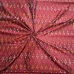 Ethnic ikat fabric draped to highlight its rich texture and colors