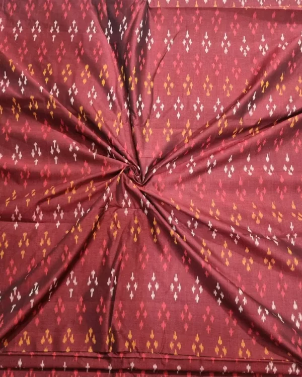Ethnic ikat fabric draped to highlight its rich texture and colors
