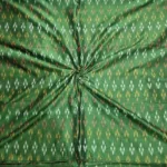 Handwoven ikat fabric with traditional geometric pattern in vibrant colors