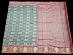 Photo of a handwoven semi-silk Pochampally saree featuring vibrant ikat diamond and temple motifs, showing the broad patterned border and pallu alongside a matching blouse piece.