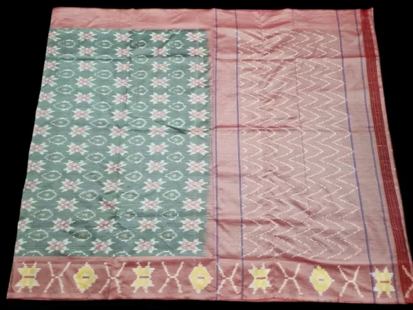Photo of a handwoven semi-silk Pochampally saree featuring vibrant ikat diamond and temple motifs, showing the broad patterned border and pallu alongside a matching blouse piece.