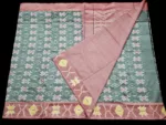 Photo of a handwoven semi-silk Pochampally saree featuring vibrant ikat diamond and temple motifs, showing the broad patterned border and pallu alongside a matching blouse piece.