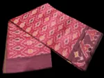 Close-up of a handwoven semi-silk Pochampally saree showing vibrant ikat diamond and temple motifs on a broad border
