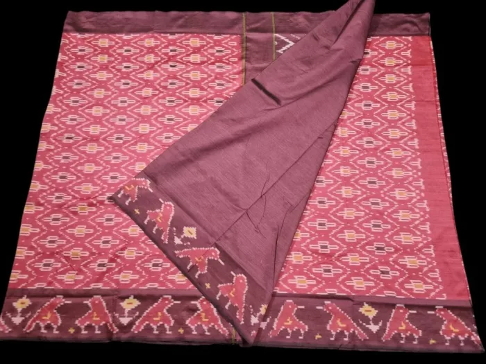 Close-up of a handwoven semi-silk Pochampally saree showing vibrant ikat diamond and temple motifs on a broad border