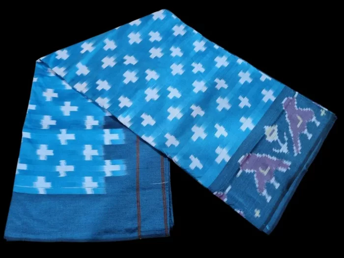 Close-up of a handwoven semi-silk Pochampally saree showing vibrant ikat diamond and temple motifs on a broad border