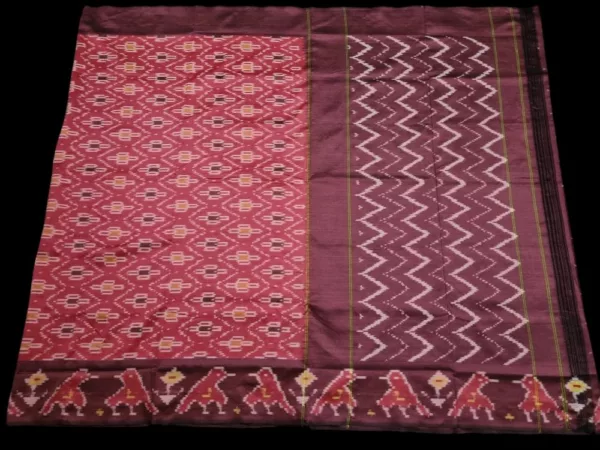 Close-up of a handwoven semi-silk Pochampally saree showing vibrant ikat diamond and temple motifs on a broad border