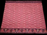 Close-up of a handwoven semi-silk Pochampally saree showing vibrant ikat diamond and temple motifs on a broad border
