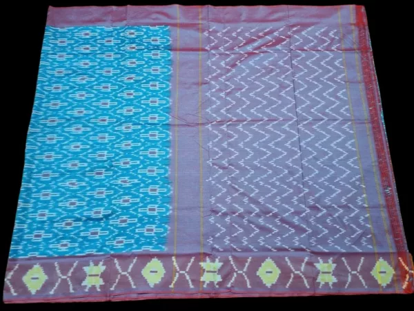 Close-up of a handwoven semi-silk Pochampally saree showing vibrant ikat diamond and temple motifs on a broad border