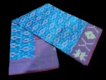 Close-up of a handwoven semi-silk Pochampally saree showing vibrant ikat diamond and temple motifs on a broad border