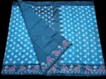 Close-up of a handwoven semi-silk Pochampally saree showing vibrant ikat diamond and temple motifs on a broad border