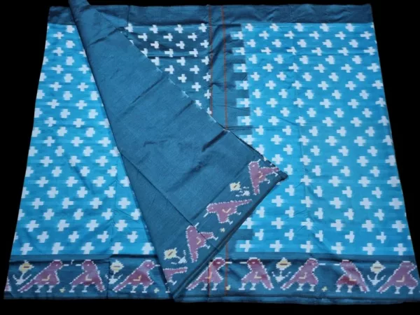 Close-up of a handwoven semi-silk Pochampally saree showing vibrant ikat diamond and temple motifs on a broad border