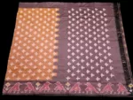Close-up of a handwoven semi-silk Pochampally saree showing vibrant ikat diamond and temple motifs on a broad border