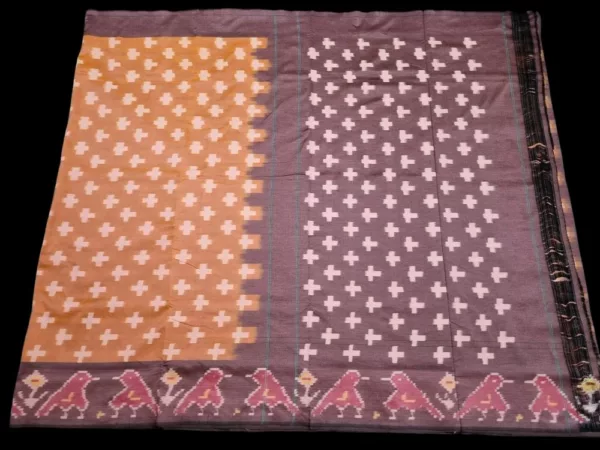 Close-up of a handwoven semi-silk Pochampally saree showing vibrant ikat diamond and temple motifs on a broad border