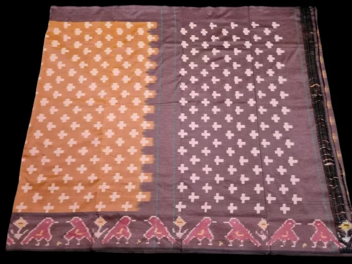 Close-up of a handwoven semi-silk Pochampally saree showing vibrant ikat diamond and temple motifs on a broad border