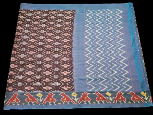 Close-up of a handwoven semi-silk Pochampally saree showing vibrant ikat diamond and temple motifs on a broad border