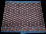 Close-up of a handwoven semi-silk Pochampally saree showing vibrant ikat diamond and temple motifs on a broad border