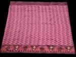 Close-up of a handwoven semi-silk Pochampally saree showing vibrant ikat diamond and temple motifs on a broad border