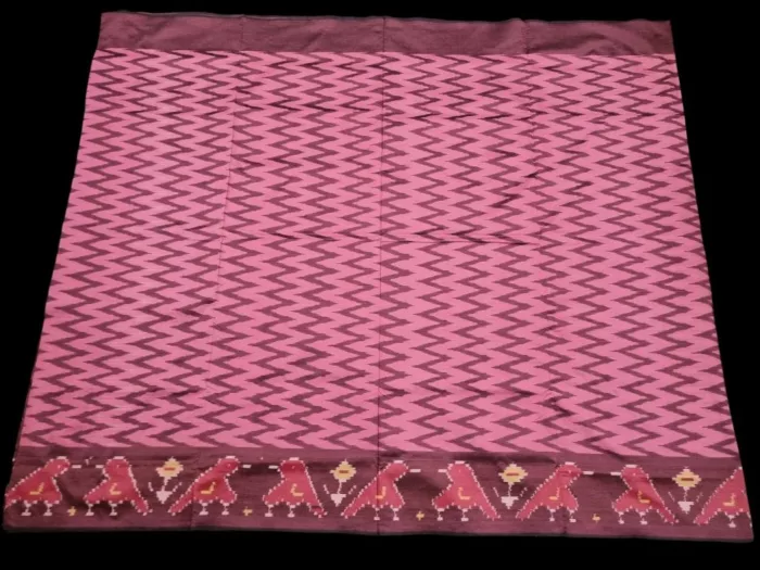 Close-up of a handwoven semi-silk Pochampally saree showing vibrant ikat diamond and temple motifs on a broad border