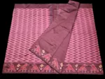 Close-up of a handwoven semi-silk Pochampally saree showing vibrant ikat diamond and temple motifs on a broad border