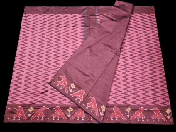 Close-up of a handwoven semi-silk Pochampally saree showing vibrant ikat diamond and temple motifs on a broad border