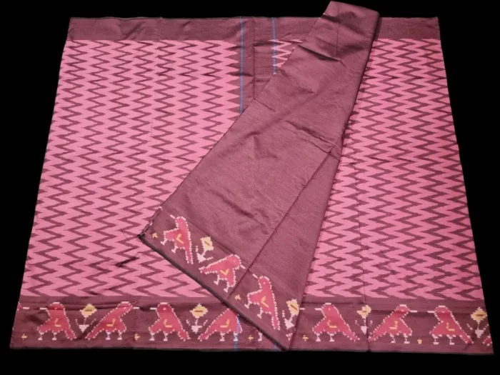 Close-up of a handwoven semi-silk Pochampally saree showing vibrant ikat diamond and temple motifs on a broad border