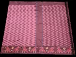 Close-up of a handwoven semi-silk Pochampally saree showing vibrant ikat diamond and temple motifs on a broad border