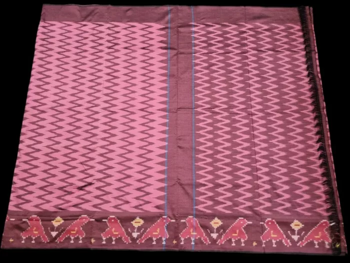 Close-up of a handwoven semi-silk Pochampally saree showing vibrant ikat diamond and temple motifs on a broad border