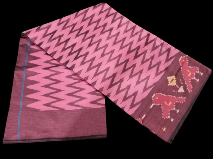 Close-up of a handwoven semi-silk Pochampally saree showing vibrant ikat diamond and temple motifs on a broad border