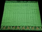 Close-up of a handwoven semi-silk Pochampally saree showing vibrant ikat diamond and temple motifs on a broad border