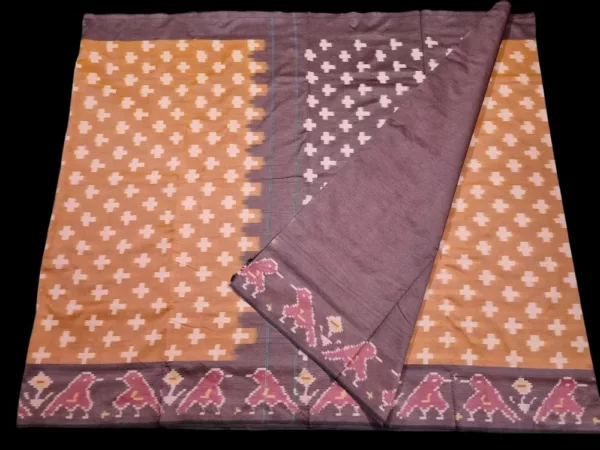 Close-up of a handwoven semi-silk Pochampally saree showing vibrant ikat diamond and temple motifs on a broad border