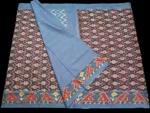 Close-up of a handwoven semi-silk Pochampally saree showing vibrant ikat diamond and temple motifs on a broad border